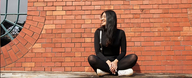 A PG student smiles in Bristol city centre.